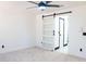 Bright bedroom featuring stylish sliding doors to the ensuite bathroom at 5443 Aeolus Way, Orlando, FL 32808