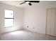 Bright, minimalist bedroom with a large window and closet with a light-colored carpet at 5443 Aeolus Way, Orlando, FL 32808