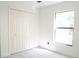 Bedroom with plush carpeting, bi-fold closet doors and natural light from the window at 5443 Aeolus Way, Orlando, FL 32808