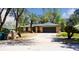 Beautiful single-story home with a two-car garage and a well-manicured front yard with mature trees at 5443 Aeolus Way, Orlando, FL 32808