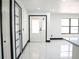 Bright foyer with marble floors and an entryway featuring a white door at 5443 Aeolus Way, Orlando, FL 32808