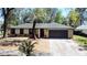 Charming single-story home with a well-maintained yard and mature landscaping and a two car garage at 5443 Aeolus Way, Orlando, FL 32808