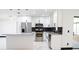 Modern kitchen featuring stainless steel appliances, an island, and polished marble floors at 5443 Aeolus Way, Orlando, FL 32808