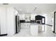 Modern kitchen with stainless steel appliances, black backsplash, an island, and polished marble floors at 5443 Aeolus Way, Orlando, FL 32808