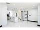 Bright, open kitchen with an island, pendant lighting, and stainless steel appliances with polished marble floors at 5443 Aeolus Way, Orlando, FL 32808