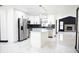 Modern kitchen with stainless steel appliances, black backsplash, an island, and polished marble floors at 5443 Aeolus Way, Orlando, FL 32808