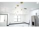 Living room with white walls, black trim, modern pendant lights, large windows and tile floor at 5443 Aeolus Way, Orlando, FL 32808