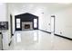 Open-concept living area featuring a sleek fireplace, lots of light, and polished marble floors at 5443 Aeolus Way, Orlando, FL 32808