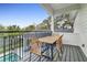 Balcony featuring an outdoor table, chairs, and view of the back yard pool at 599 Glendevon Dr, New Smyrna Beach, FL 32168