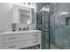 Modern bathroom featuring stylish shower with glass enclosure, vanity with storage, and elegant tiling at 599 Glendevon Dr, New Smyrna Beach, FL 32168