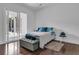 Bright bedroom with modern decor, hardwood floors, and sliding glass doors leading to the outdoors at 599 Glendevon Dr, New Smyrna Beach, FL 32168