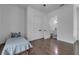 Bright bedroom features wood floors, single bed, closet and door to the modern bathroom at 599 Glendevon Dr, New Smyrna Beach, FL 32168