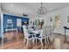 Elegant dining area with stylish chandelier, comfortable seating, and seamless connection to the living room at 599 Glendevon Dr, New Smyrna Beach, FL 32168