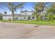 Charming two-story home features a welcoming porch, mature trees, and well-maintained landscaping at 599 Glendevon Dr, New Smyrna Beach, FL 32168