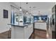 Well-lit kitchen with center island, modern appliances, and seamless connection to the living area at 599 Glendevon Dr, New Smyrna Beach, FL 32168