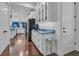 Bright, open kitchen showcasing a marble countertop, modern cabinets, and hardwood floors at 599 Glendevon Dr, New Smyrna Beach, FL 32168