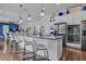 Modern kitchen with a large island, stainless steel appliances, and stylish pendant lighting at 599 Glendevon Dr, New Smyrna Beach, FL 32168