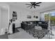 Bright living room with modern decor, gray sofa, and access to a large patio at 599 Glendevon Dr, New Smyrna Beach, FL 32168