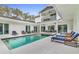 Beautiful pool area featuring lounge chairs and an upper balcony, ideal for relaxation and entertaining outdoors at 599 Glendevon Dr, New Smyrna Beach, FL 32168