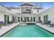 Stunning pool area with lounge chairs and upper deck, perfect for outdoor relaxation and entertainment at 599 Glendevon Dr, New Smyrna Beach, FL 32168