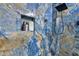 Close-up of the bathroom shower with blue marble tiling and modern fixture at 599 Glendevon Dr, New Smyrna Beach, FL 32168