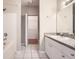 Bright bathroom features a vanity with cabinets, a shower-tub, and storage closet at 6340 Raleigh St # 1002, Orlando, FL 32835