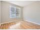 Cozy bedroom featuring hardwood floors and a bright window, offering comfort and style at 6340 Raleigh St # 1002, Orlando, FL 32835
