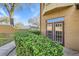 Charming exterior view features a well-maintained facade with a garden and French doors at 6340 Raleigh St # 1002, Orlando, FL 32835