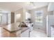 Efficient kitchen with a breakfast bar and white appliances, enhanced by natural light at 6340 Raleigh St # 1002, Orlando, FL 32835