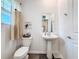 Well-lit half bath with pedestal sink, stylish decor, and modern fixtures at 6404 Pine Fork Aly, St Cloud, FL 34771