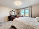 Serene bedroom featuring a stately bed, dresser, and bright windows overlooking the community at 6404 Pine Fork Aly, St Cloud, FL 34771