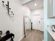 Bright entryway showcasing wood floors, a stylish mirror, and modern decor, leading to a welcoming home at 6404 Pine Fork Aly, St Cloud, FL 34771