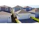 Rear view of gray and white home with 2-car garage and fenced yard at 6404 Pine Fork Aly, St Cloud, FL 34771