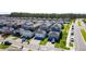 An aerial view shows a community with neatly arranged houses, each boasting a driveway and green lawn at 6404 Pine Fork Aly, St Cloud, FL 34771