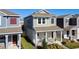 Inviting two-story home showcasing a cozy front porch with rocking chairs and a beautifully landscaped yard at 6404 Pine Fork Aly, St Cloud, FL 34771