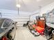 Spacious garage featuring a car, lawn equipment, cabinet and ample room for storage at 6404 Pine Fork Aly, St Cloud, FL 34771
