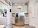 Modern kitchen design featuring stainless steel refrigerator, light gray cabinetry, and tiled flooring at 6404 Pine Fork Aly, St Cloud, FL 34771