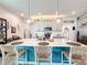 Stylish kitchen with large island, pendant lighting, breakfast bar, and modern appliances at 6404 Pine Fork Aly, St Cloud, FL 34771