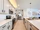 Modern kitchen with stainless steel appliances, quartz countertops, and stylish cabinetry at 6404 Pine Fork Aly, St Cloud, FL 34771