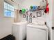Functional laundry room equipped with modern washer and dryer and ample shelving at 6404 Pine Fork Aly, St Cloud, FL 34771
