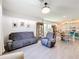 Comfortable living room with sofas, cabinet, and open access to the dining and kitchen areas at 6404 Pine Fork Aly, St Cloud, FL 34771