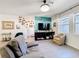 Comfortable living room with modern furniture, vibrant accent wall, and plenty of natural light at 6404 Pine Fork Aly, St Cloud, FL 34771