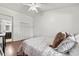 Well-lit bedroom featuring wood floors, ceiling fan, and closet with paneled doors at 703 Linden Dr, Winter Springs, FL 32708