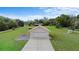 An aerial view of the garage features the backyard, surrounding trees, and a long concrete driveway at 735 Deerfoot Rd, Deland, FL 32720