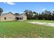 A spacious backyard features a long driveway and a partially screened-in patio area at 735 Deerfoot Rd, Deland, FL 32720