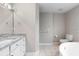 Bright bathroom featuring granite countertop vanity, tile flooring, and a soaking tub at 735 Deerfoot Rd, Deland, FL 32720