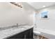 This updated bathroom boasts a granite vanity, tub with shower, updated fixtures, and bright natural light at 735 Deerfoot Rd, Deland, FL 32720