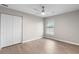 Bedroom features a ceiling fan, wood-look flooring, closet, and window with blinds at 735 Deerfoot Rd, Deland, FL 32720