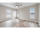 Bedroom features laminate flooring, ceiling fan, and multiple windows with blinds at 735 Deerfoot Rd, Deland, FL 32720