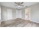 Spacious bedroom featuring an ensuite bathroom, wood floors, and an overhead fan at 735 Deerfoot Rd, Deland, FL 32720